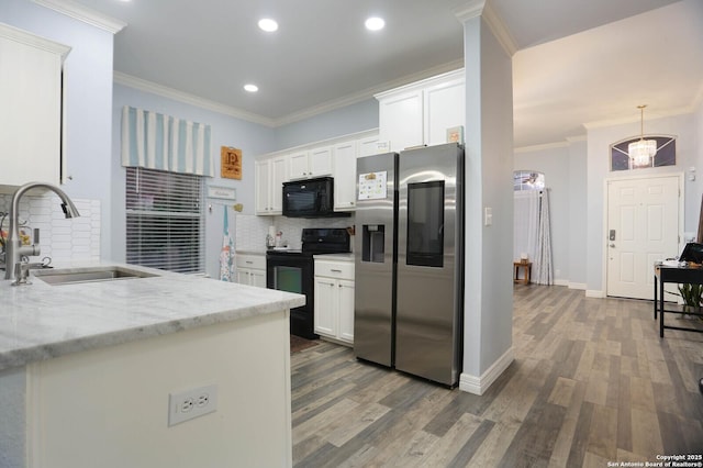 kitchen featuring black appliances, a sink, backsplash, white cabinetry, and ornamental molding