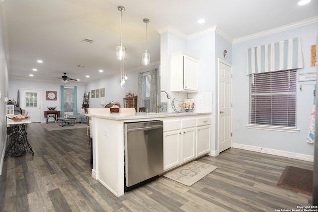 kitchen featuring dishwasher, crown molding, a sink, dark wood-style floors, and a peninsula