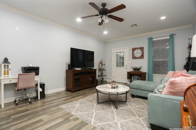 living room with a ceiling fan, wood finished floors, crown molding, an office area, and baseboards