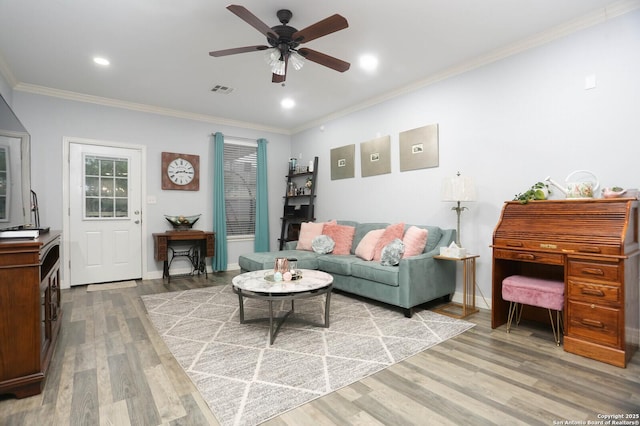 living area with ornamental molding, wood finished floors, ceiling fan, recessed lighting, and baseboards