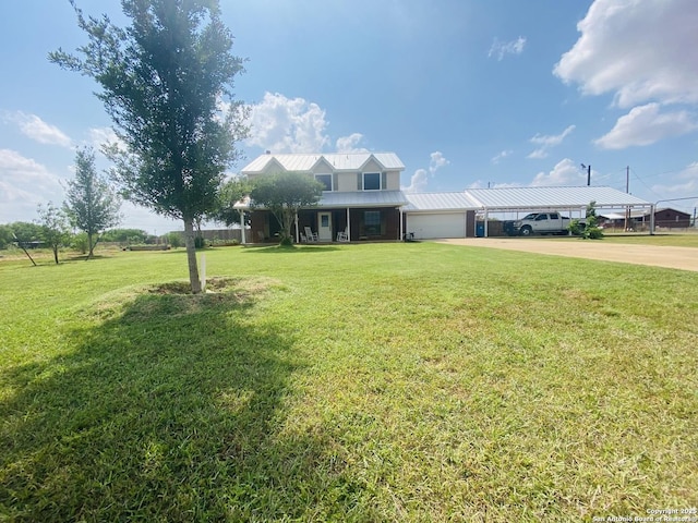 606 S Phelps St, Dilley, TX 78017 - farmhouse with driveway, an attached garage, a front yard, a carport, and metal roof