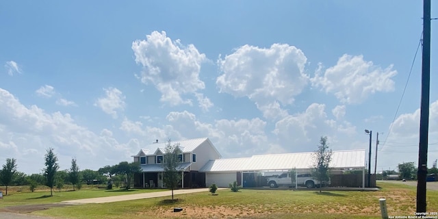 606 S Phelps St, Dilley, TX 78017 - view of community with driveway, a lawn, and a garage