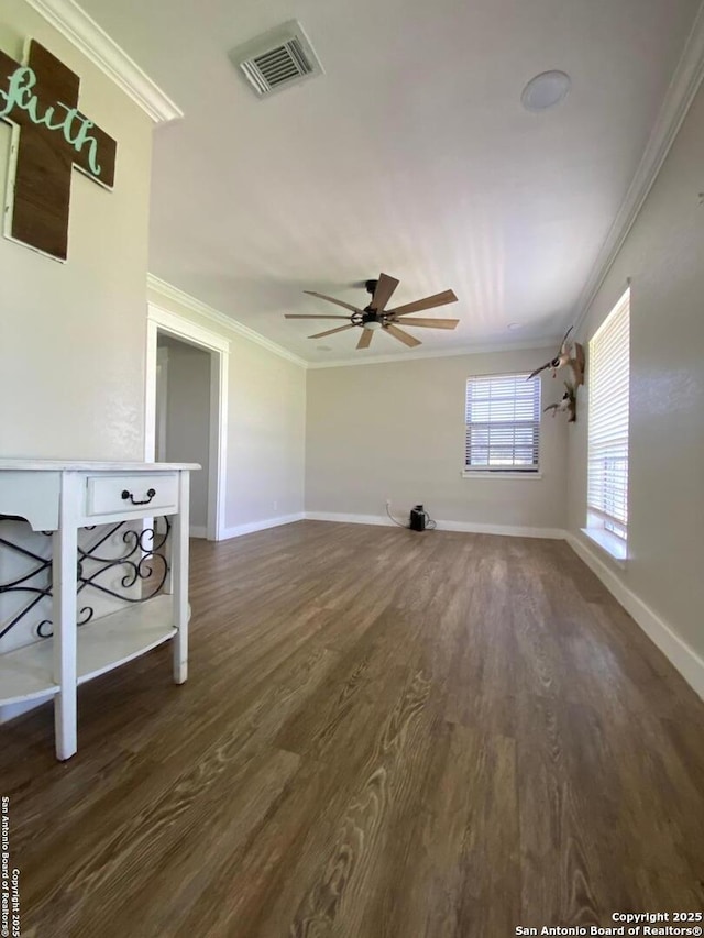 606 S Phelps St, Dilley, TX 78017 - unfurnished living room featuring ornamental molding, ceiling fan, wood finished floors, and baseboards