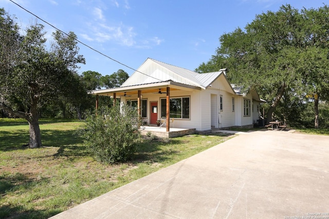 6160 Fm 2538, Marion, TX 78124 - view of front of home with ceiling fan, a front lawn, concrete driveway, metal roof, and a porch