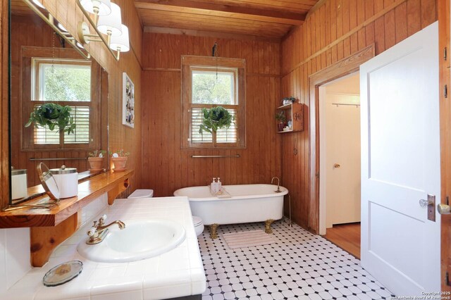 6160 Fm 2538, Marion, TX 78124 - bathroom with wooden walls, wooden ceiling, a freestanding tub, vanity, and tile patterned floors