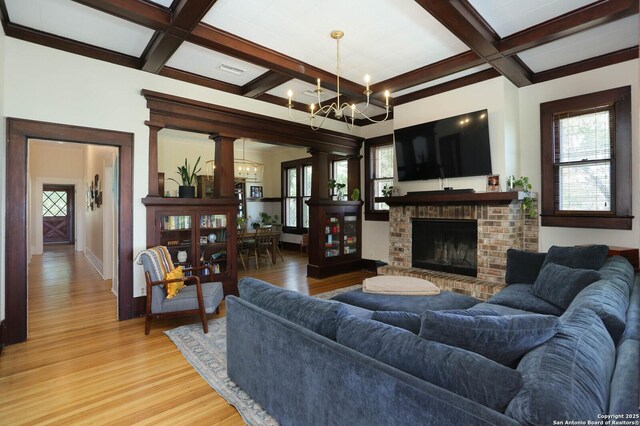 6160 Fm 2538, Marion, TX 78124 - living room with coffered ceiling, a chandelier, light wood-style flooring, beamed ceiling, and a brick fireplace