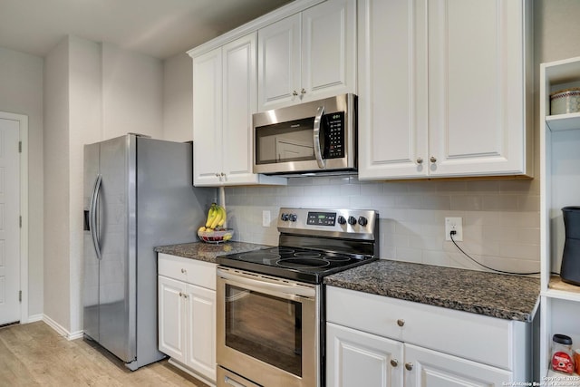 6039 Olson Blfs, San Antonio, TX 78252 - kitchen featuring appliances with stainless steel finishes, white cabinets, decorative backsplash, light wood-style flooring, and dark stone countertops