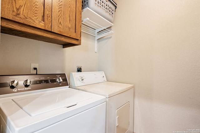 laundry room featuring cabinet space and washing machine and dryer