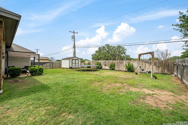 view of yard featuring a storage shed and an outbuilding