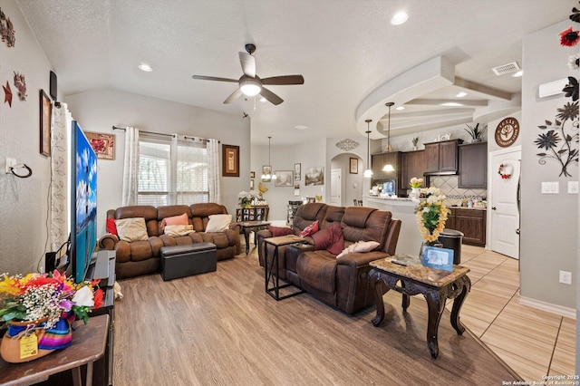 8707 Kallison Arbor, San Antonio, TX 78254 - living room with ceiling fan, arched walkways, recessed lighting, a textured ceiling, and vaulted ceiling