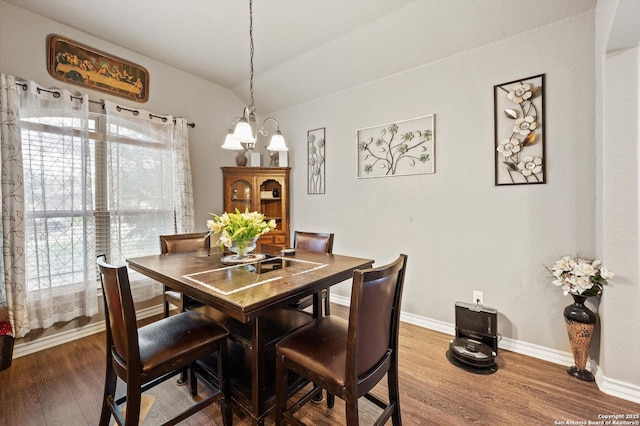 8707 Kallison Arbor, San Antonio, TX 78254 - dining space featuring wood finished floors, vaulted ceiling, baseboards, and a chandelier