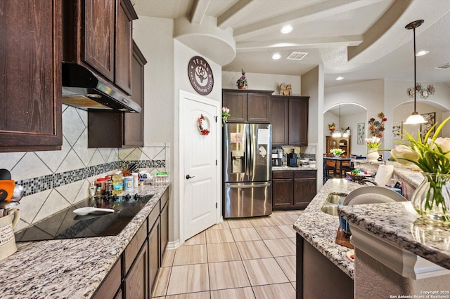 8707 Kallison Arbor, San Antonio, TX 78254 - kitchen featuring stainless steel refrigerator with ice dispenser, under cabinet range hood, arched walkways, decorative backsplash, and light tile patterned flooring