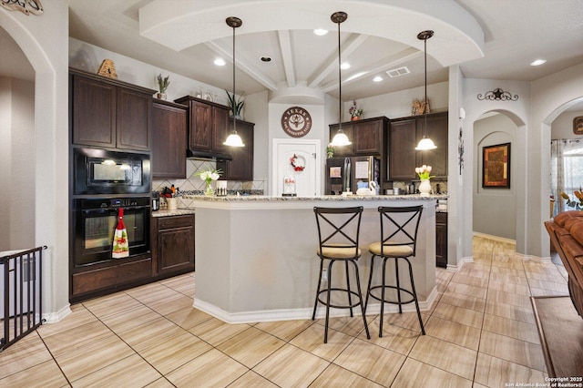 8707 Kallison Arbor, San Antonio, TX 78254 - kitchen featuring black appliances, arched walkways, tasteful backsplash, dark brown cabinets, and recessed lighting