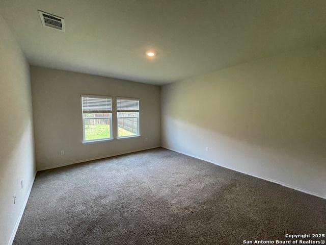 spare room featuring carpet flooring, baseboards, and recessed lighting