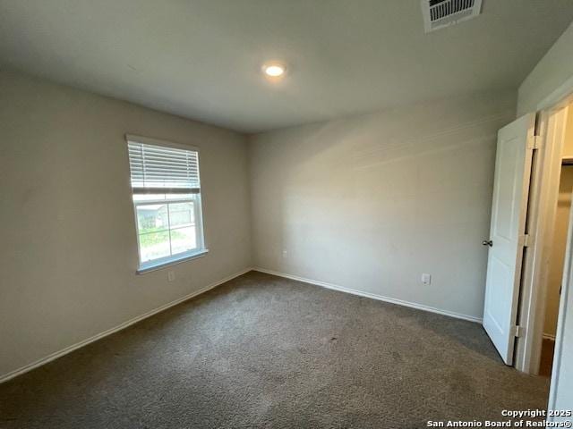 unfurnished bedroom featuring dark colored carpet, baseboards, and recessed lighting