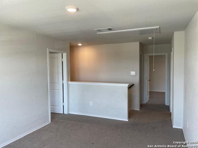spare room with attic access, carpet flooring, recessed lighting, and baseboards