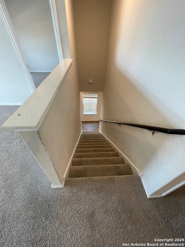 staircase with carpet and baseboards