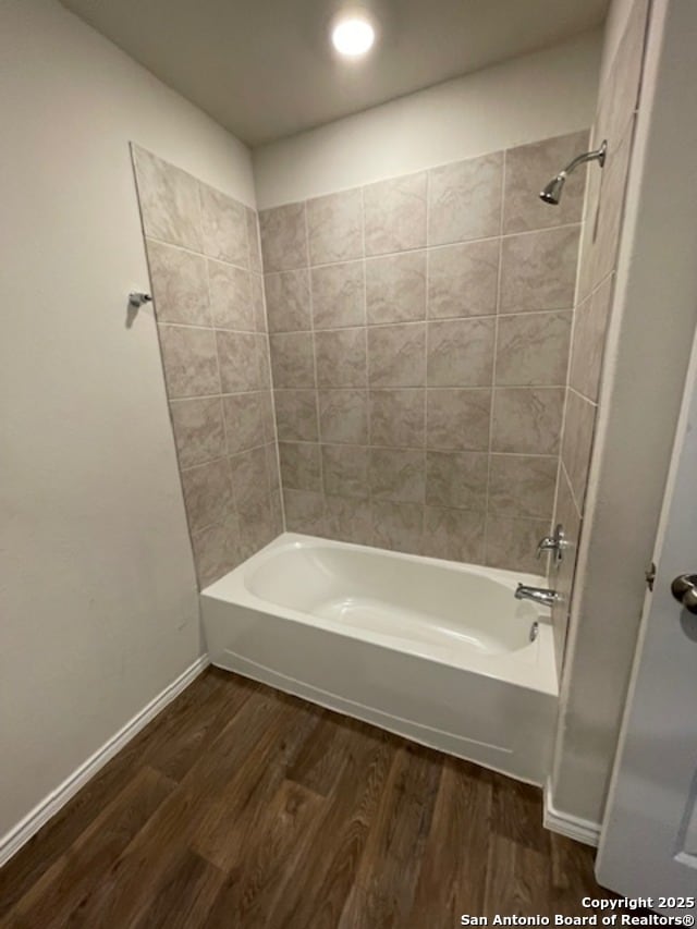full bath featuring wood finished floors, shower / bath combination, baseboards, and recessed lighting