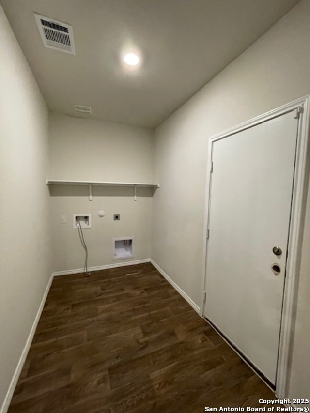washroom featuring electric dryer hookup, hookup for a gas dryer, dark wood-type flooring, and baseboards