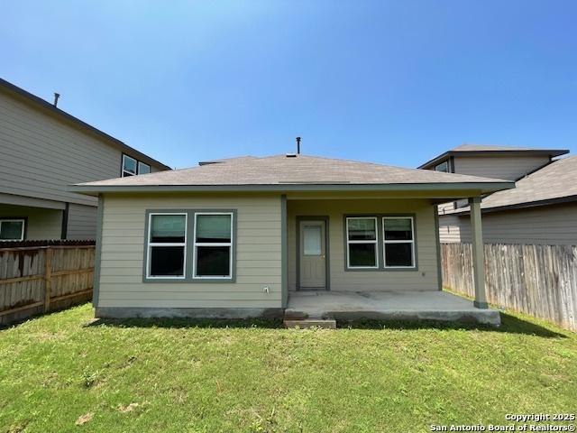 back of property with roof with shingles