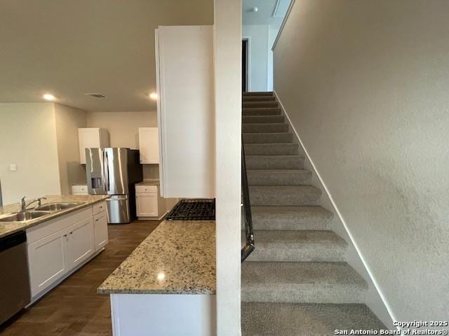 staircase featuring wood finished floors, recessed lighting, and baseboards