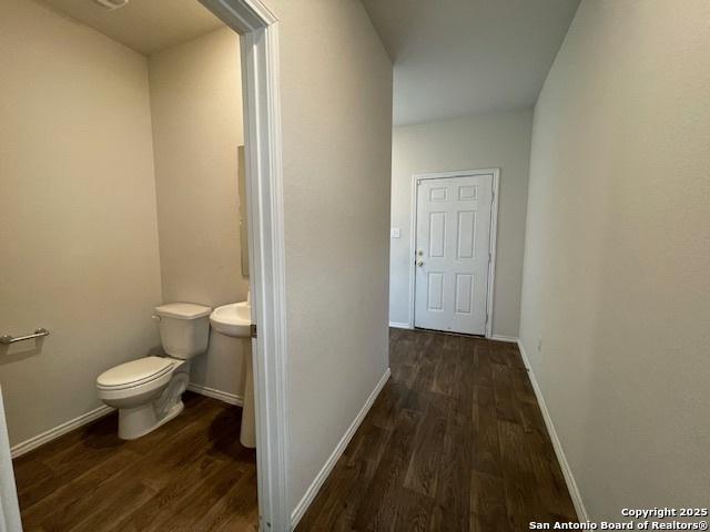 hall with wood finished floors and baseboards