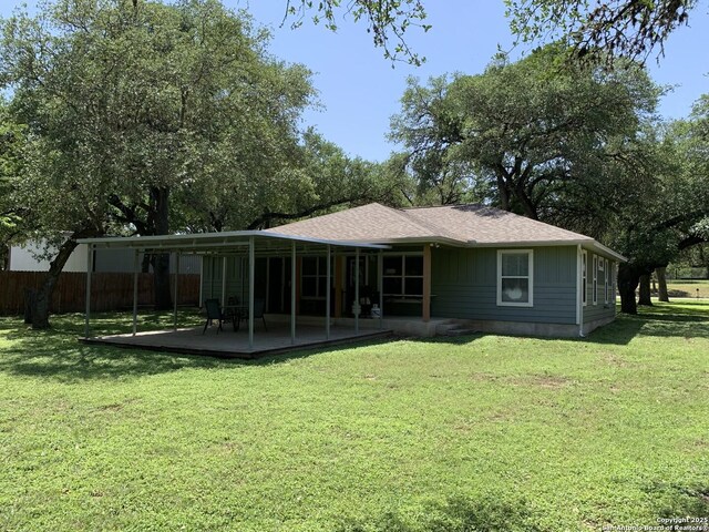 back of house with a wooden deck and roof with shingles