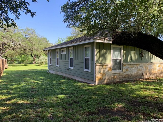 view of property exterior featuring board and batten siding and stone siding