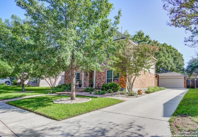 view of property hidden behind natural elements with brick siding, a front yard, and a garage