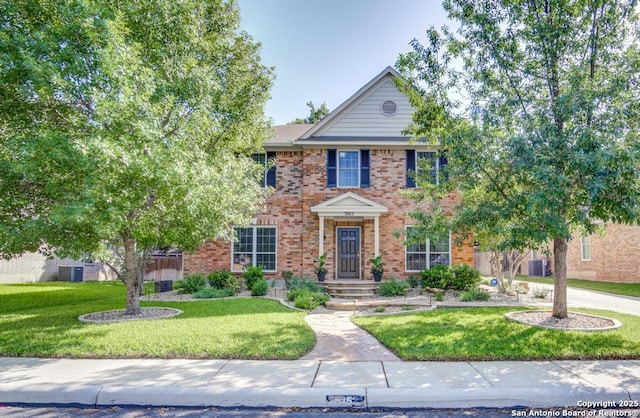 colonial-style house with a front lawn, brick siding, and cooling unit