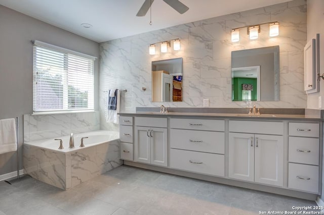 full bath featuring a bath, ceiling fan, and double vanity