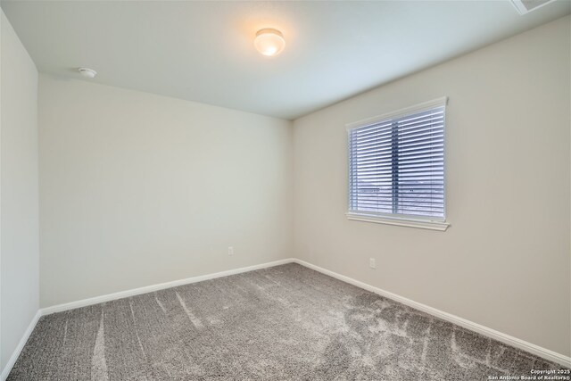 1109 Esplanade Pkwy, San Marcos, TX 78666 - carpeted empty room with baseboards and a smoke detector