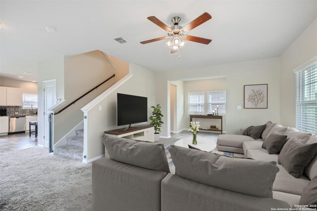1109 Esplanade Pkwy, San Marcos, TX 78666 - living area with stairs, a ceiling fan, light colored carpet, and baseboards