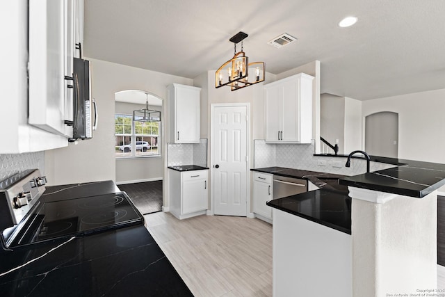 3727 Columbia, Cibolo, TX 78108 - kitchen with arched walkways, appliances with stainless steel finishes, a sink, white cabinetry, and tasteful backsplash