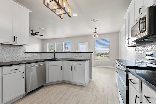 3727 Columbia, Cibolo, TX 78108 - kitchen featuring appliances with stainless steel finishes, a chandelier, tasteful backsplash, a sink, and a peninsula