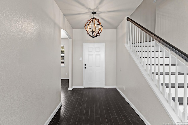 3727 Columbia, Cibolo, TX 78108 - foyer with arched walkways, baseboards, a chandelier, stairs, and dark wood-style floors