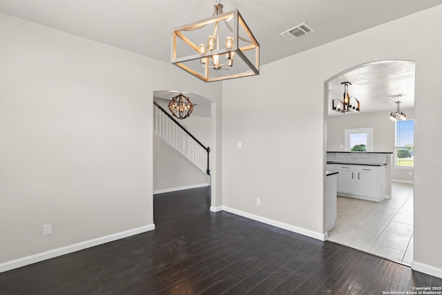 3727 Columbia, Cibolo, TX 78108 - unfurnished room featuring a chandelier, wood finished floors, arched walkways, and baseboards