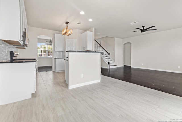 3727 Columbia, Cibolo, TX 78108 - kitchen with arched walkways, white cabinets, a ceiling fan, dark countertops, and recessed lighting