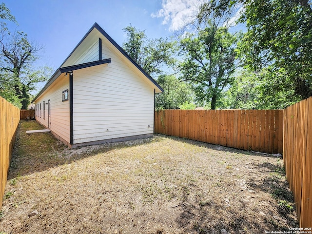 view of side of home with a fenced backyard