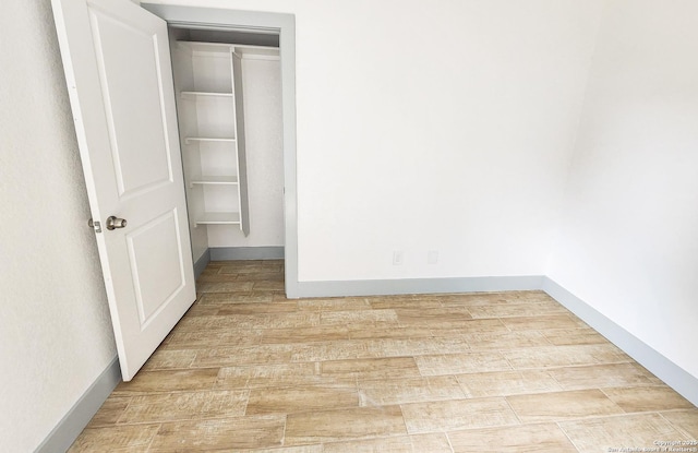 spare room with wood finished floors