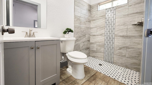 full bath with walk in shower, vanity, toilet, and wood finished floors