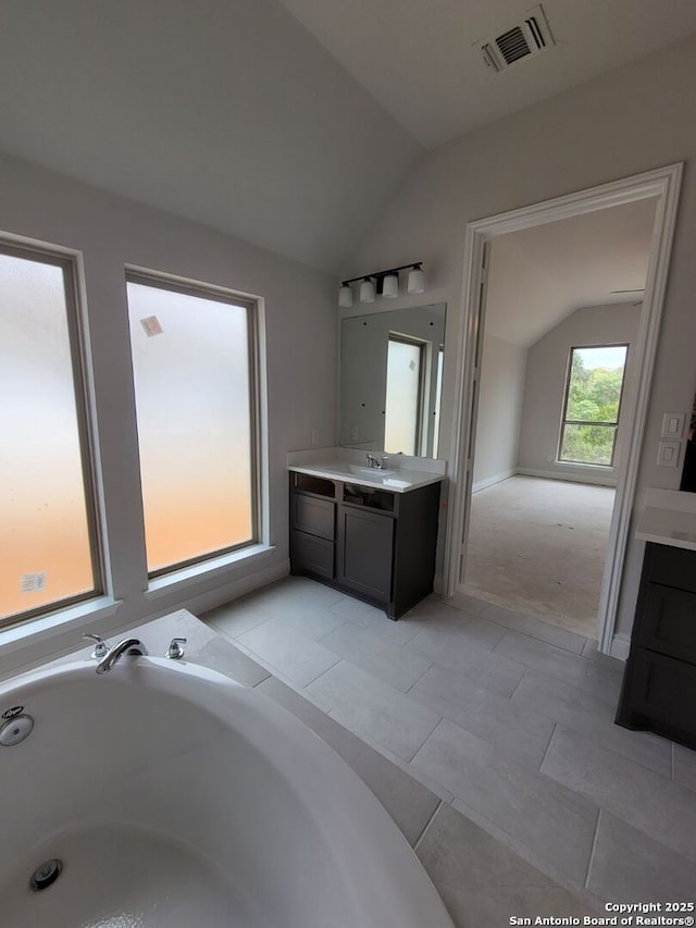 14074 May Mist, San Antonio, TX 78253 - bathroom with lofted ceiling, vanity, and a bath