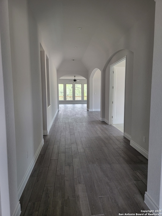 14074 May Mist, San Antonio, TX 78253 - hall with arched walkways, dark wood-style floors, lofted ceiling, and baseboards