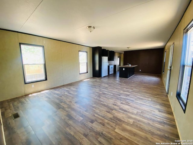 311 N Darlington, Dilley, TX 78017 - unfurnished living room featuring wood finished floors