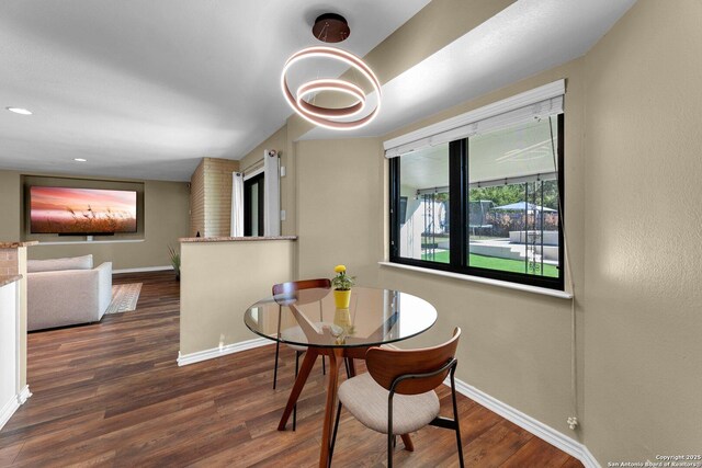 dining room featuring baseboards, wood finished floors, and recessed lighting