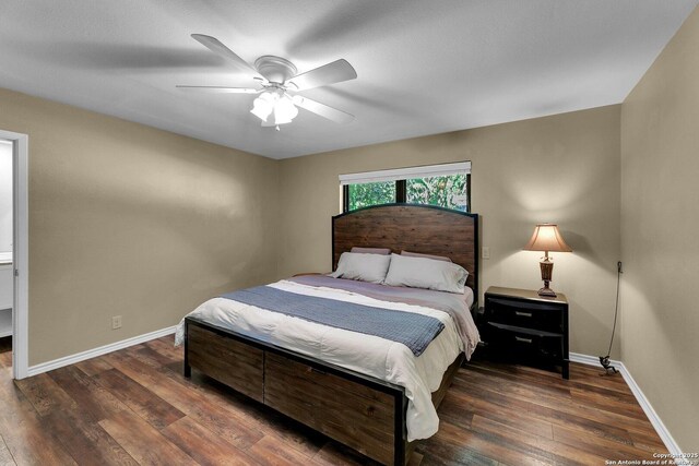 bedroom featuring wood finished floors, baseboards, and ceiling fan