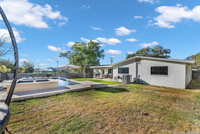 view of yard featuring central AC unit and a patio area