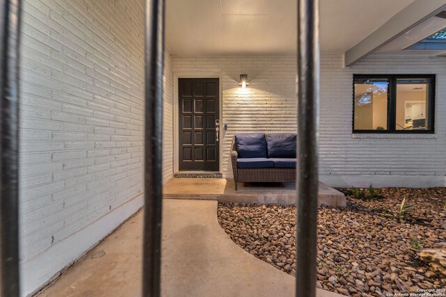 property entrance featuring brick siding
