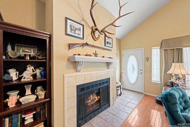 239 Old Oaks, Kerrville, TX 78028 - foyer featuring vaulted ceiling, a tile fireplace, and wood finished floors