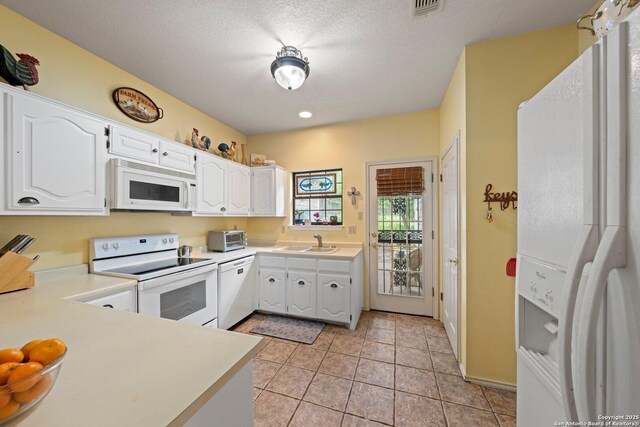 239 Old Oaks, Kerrville, TX 78028 - kitchen featuring white appliances, a sink, light countertops, and white cabinets